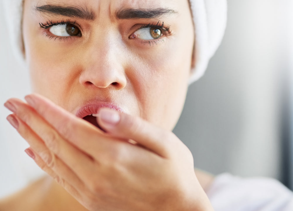 women checking for bad breath